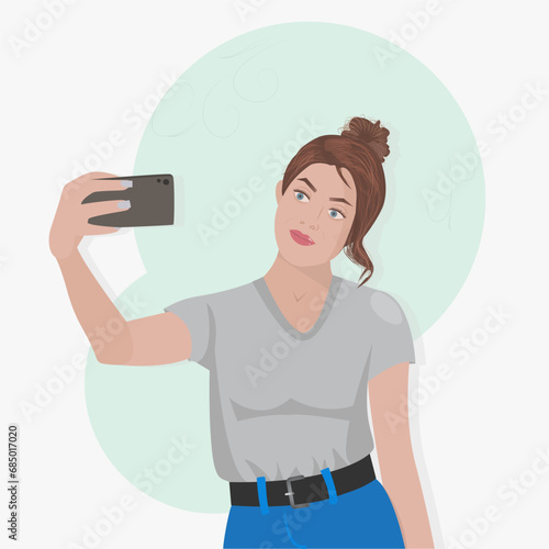 Modern girl blogger in jeans photographs herself. An attractive young woman takes selfie on mobile phone camera.