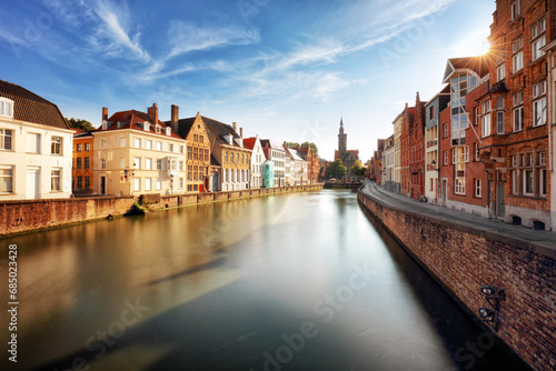 Bruges, Belgium - Scenic cityscape with canal Spiegelrei and Jan Van Eyck Square photo