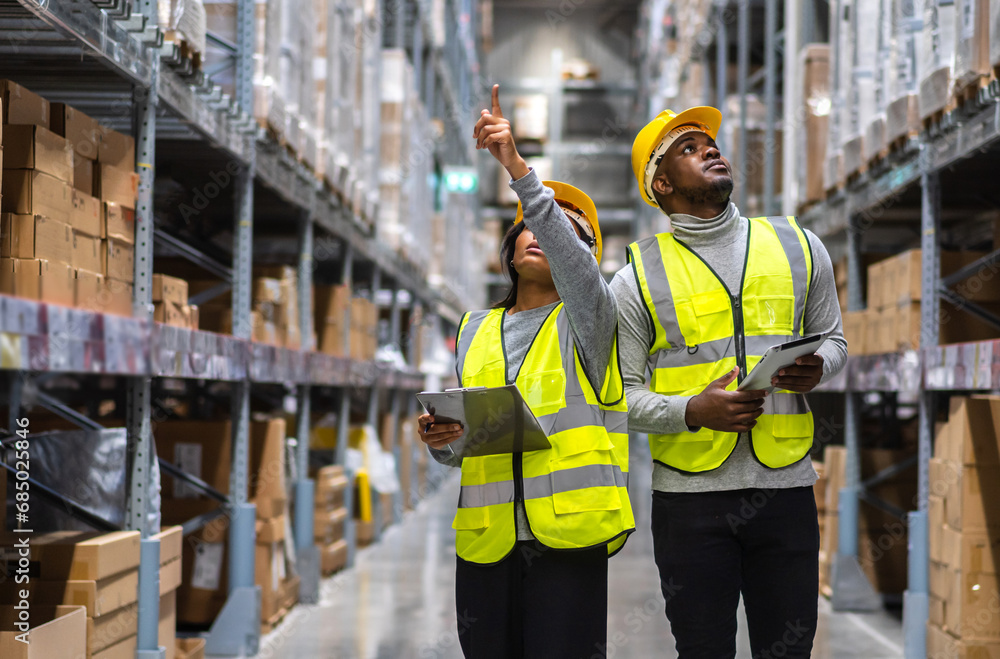 Portrait two african american engineer shipping order detail export, import,industry 4.0,goods,factory,warehouse,international trade,transportation,cargo ship,logistic,distribution.business industry. Portrait two african american engineer shipping order detail export, import,industry 4.0,goods,factory,warehouse,international trade,transportation,cargo ship,logistic,distribution.business industry.