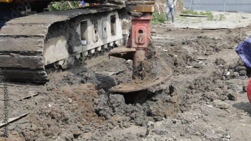 Rotary drilling rig machine auger gets into hole to dig deeper on deep foundation