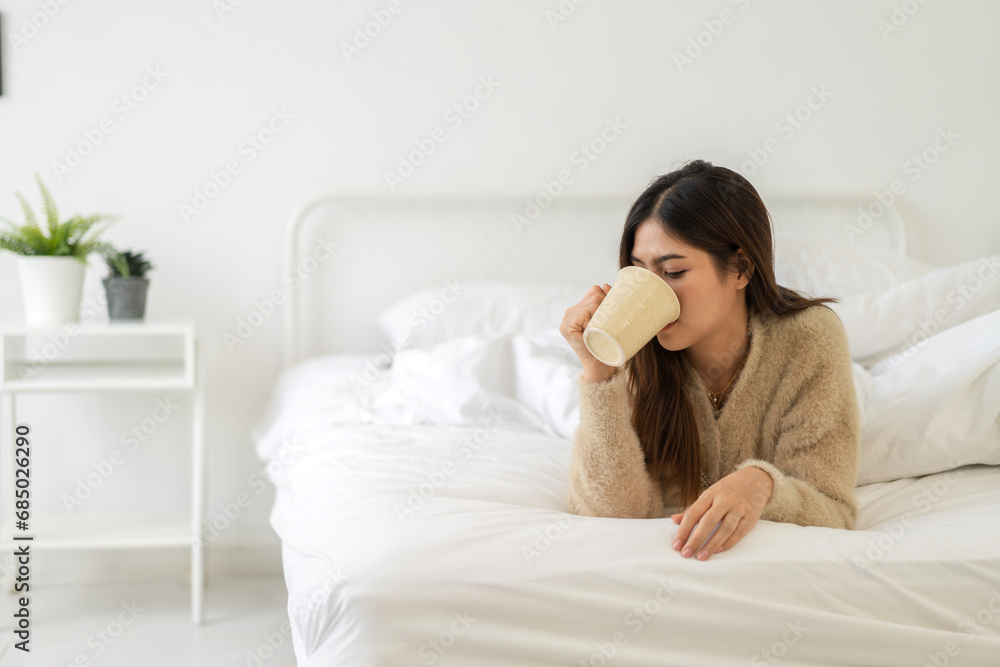 Portrait of smiling happy cheerful beauty pretty asian woman relaxing drinking and looking at cup of hot coffee or tea.Girl felling enjoy having breakfast in holiday morning vacation at home. Portrait of smiling happy cheerful beauty pretty asian woman relaxing drinking and looking at cup of hot coffee or tea.Girl felling enjoy having breakfast in holiday morning vacation at home.