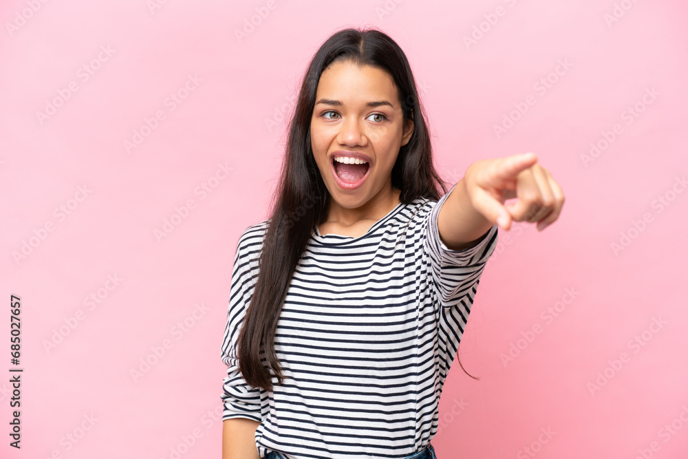 Young Colombian woman isolated on pink background pointing away Young Colombian woman isolated on pink background pointing away