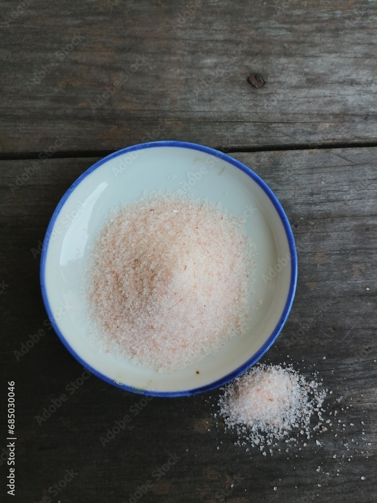 Himalayan pink salt on table wood background Himalayan pink salt on table wood background