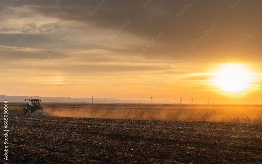 Farmer preparing his field in a tractor Farmer preparing his field in a tractor