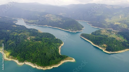Aerial view of clear blue lake and wooded hills surrounding it in Zaovine photo