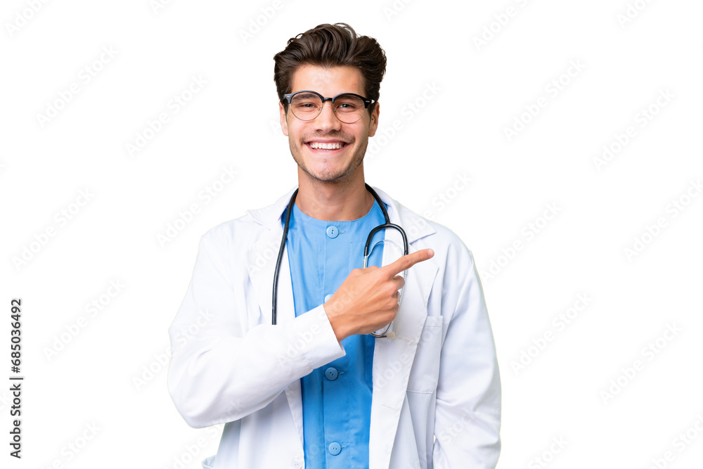 Young doctor man over isolated background pointing to the side to present a product Young doctor man over isolated background pointing to the side to present a product