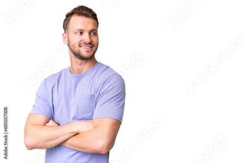 Young handsome caucasian man over isolated chroma key background looking to the side and smiling