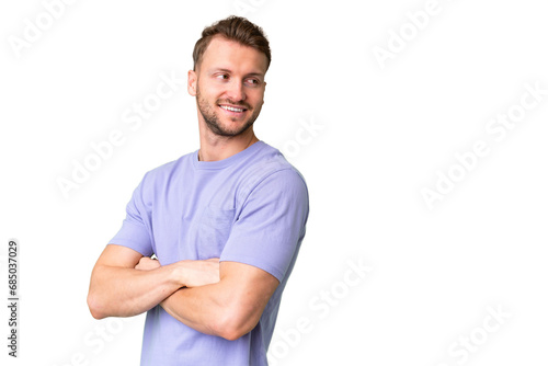 Young handsome caucasian man over isolated chroma key background with arms crossed and happy