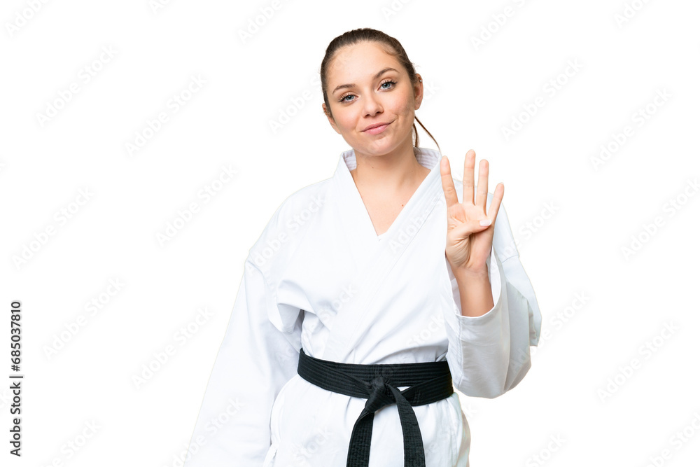 Young blonde woman doing karate over isolated chroma key background happy and counting four with fingers Young blonde woman doing karate over isolated chroma key background happy and counting four with fingers