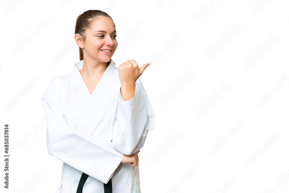 Young blonde woman over isolated chroma key background pointing to the side to present a product