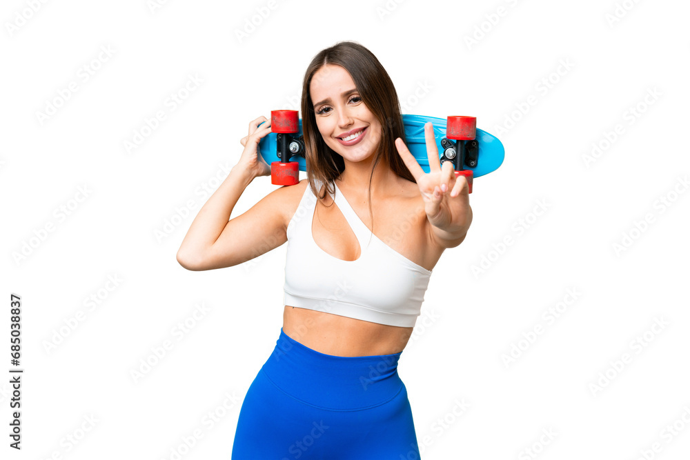Young beautiful woman over isolated chroma key background with a skate doing victory gesture Young beautiful woman over isolated chroma key background with a skate doing victory gesture