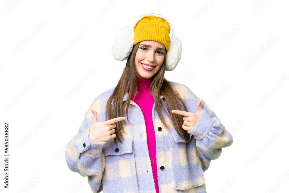 Young woman wearing winter muffs over isolated chroma key background proud and self-satisfied Young woman wearing winter muffs over isolated chroma key background proud and self-satisfied