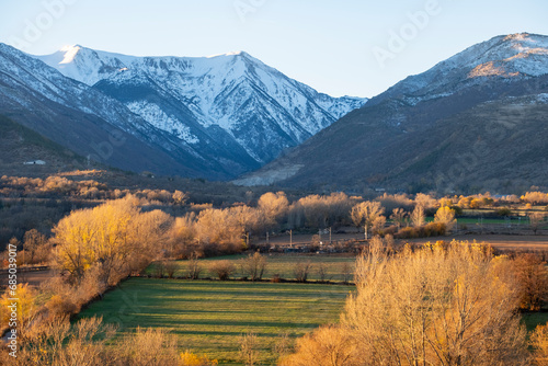 Natural landscape with snow-capped Pyrenees mountains in the autumn seen from the town of Puigcerda in Cerdanya in the province of Girona in Spain