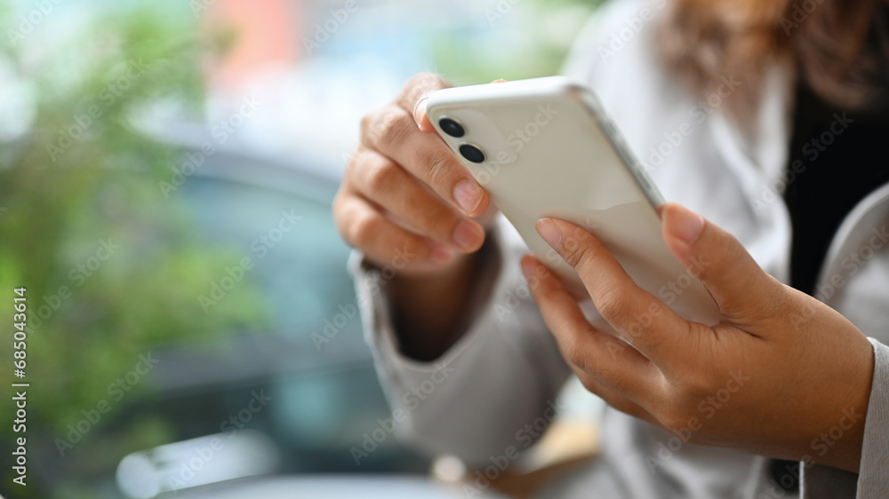 Young woman using mobile phone typing messages or communicating in social network Young woman using mobile phone typing messages or communicating in social network