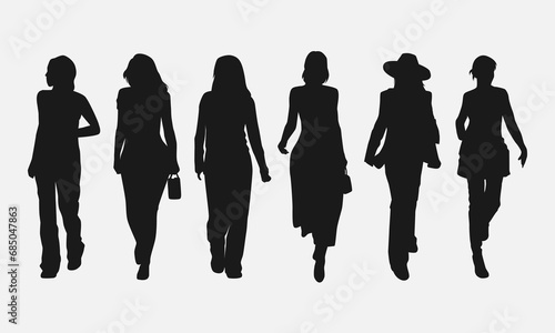 set of silhouettes of women walking forward. isolated on white background. graphic vector illustration.