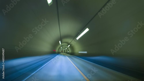 Timelapse drivelapse hyperlapse motion blur of car moving into tunnel at night, out of focus shot