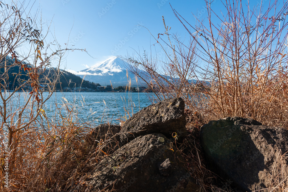 Mount Fuji on a bright winter morning, as seen from across lake Kawaguchi, and the nearby town of Kawaguchiko. Mount Fuji on a bright winter morning, as seen from across lake Kawaguchi, and the nearby town of Kawaguchiko.