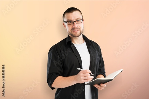 Young happy man student holding a book