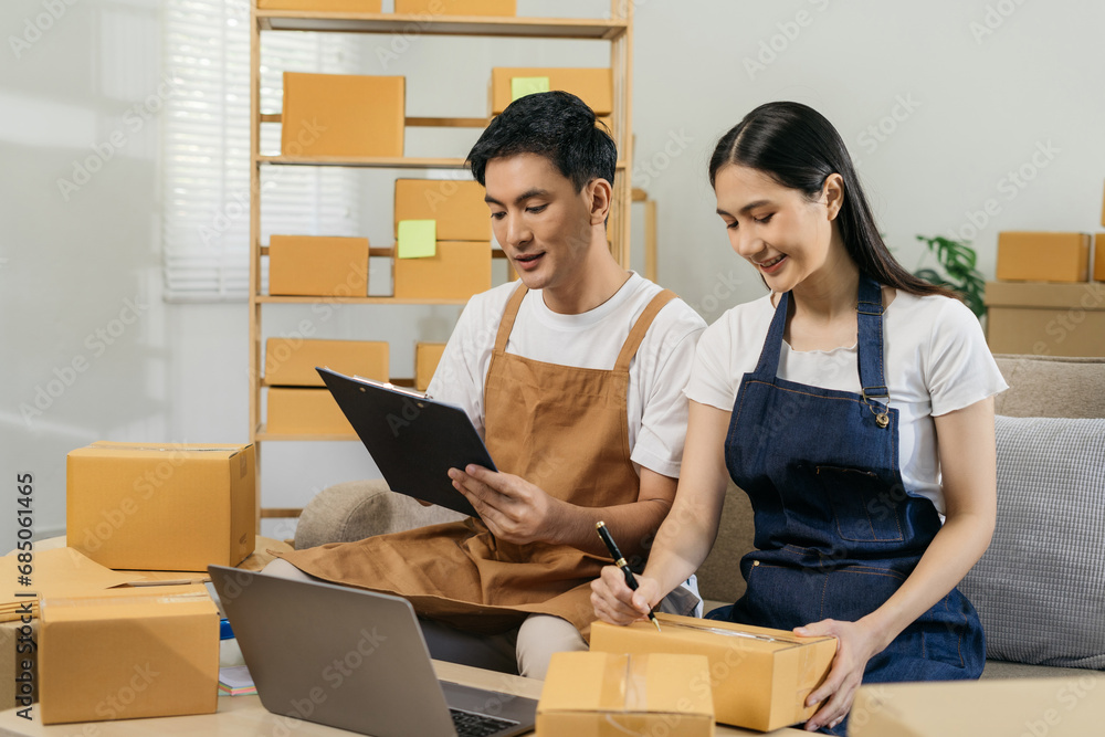 Portrait of a Small Business Startup, SMEs Owner, Couple Entrepreneur work and check orders online. Online SME business idea. Portrait of a Small Business Startup, SMEs Owner, Couple Entrepreneur work and check orders online. Online SME business idea.