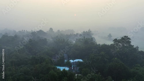 Aerial view of a village nearby a river in a foggy winter morning. Nature, travel, and rural life. Biking, cycling, hiking, travel, vacation photo