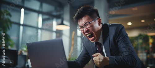 Furious Asian boss shouting at laptop man failing in twisted office copy space image