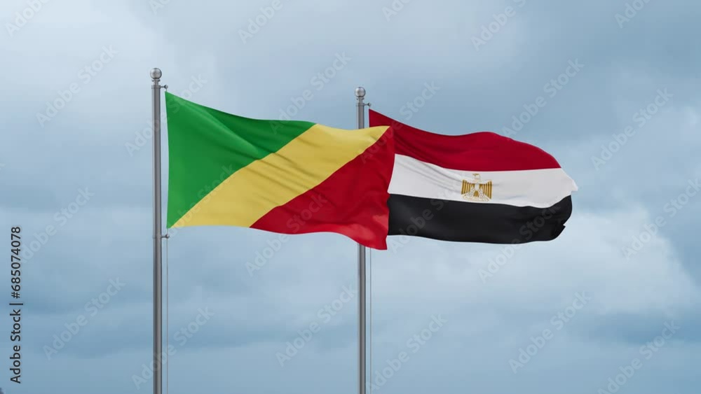 Egypt flag and Congo-Brazzaville flag waving together on cloudy sky, endless seamless loop, two country relations concept Egypt flag and Congo-Brazzaville flag waving together on cloudy sky, endless seamless loop, two country relations concept