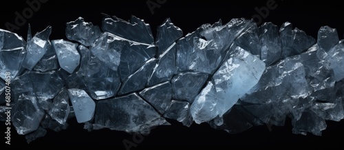 Crushed ice with cracks on black surface copy space image