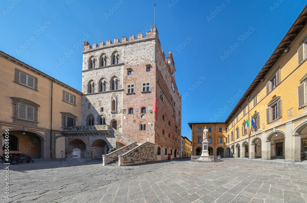 Piazza del Comune square with historic building of medieval Town Hall in Prato, Italy.