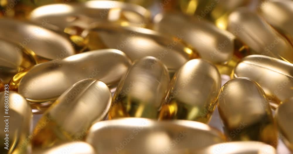 Transparent capsules with yellow oil liquid. Vitamin E concept Transparent capsules with yellow oil liquid. Vitamin E concept