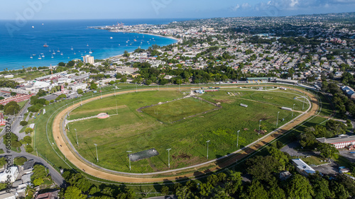 Aerial landscape view of Bay Area of Carlisle Bay at Bridgetown, Capital of Barbados with "Garrison Savannah" historic horse racetrack in front the Bay Area and Cruise Port Terminal in background