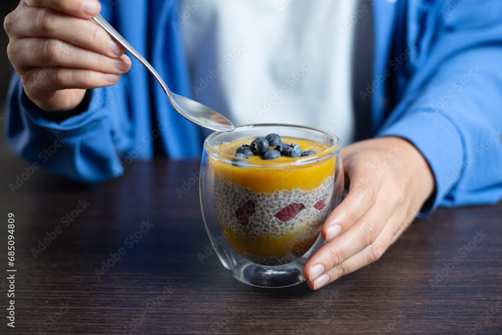 Healthy vegan dessert - chia pudding with mango aHealthy vegan dessert - chia pudding with mango and berries. Vegan eating.nd berries. Home cooking. - obrazy, fototapety, plakaty 