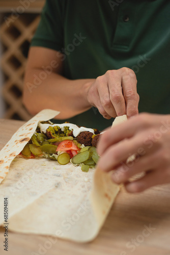 Man cooking homemade falafel meal. photo