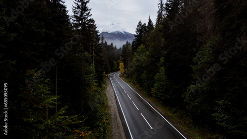 mountain road in the autumn forest of the caucasus