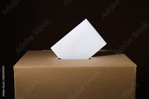 Paper voting box with form on black background