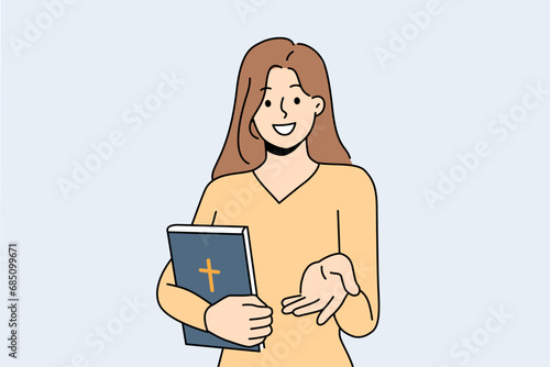 Believer woman with bible lends helping hand to people in need or invites them to christian charity organization. Girls hold book bible with catholic cross and lure parishioners in church for sermon