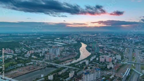 Aerial top sunset view of Moscow city panoramic timelapse. Cityscape from the observation platform of the business center of Moscow City. Moscow river and traffic on roads at summer day photo