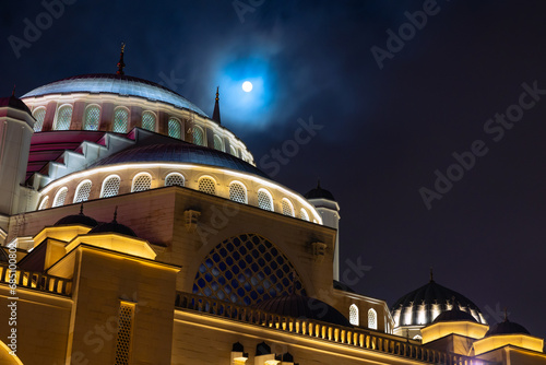 Islamic or ramadan background photo. Full moon and Buyuk Camlica Mosque photo