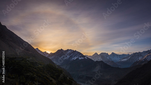 Fototapeta Naklejka Na Ścianę i Meble -  Sunrise with lens flare over vast mountains with snow