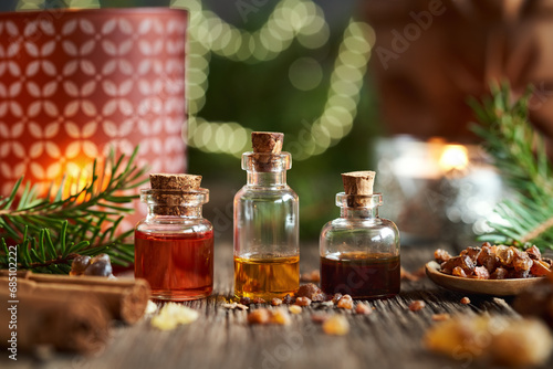 Bottles of essential oil with frankincense and myrrh resin at Christmas photo