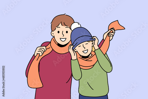 Little boys in winter hats and scarves rejoicing at onset of winter and preparing for walk in park. Boys brothers or friends having fun enjoying communication and coming of december holidays