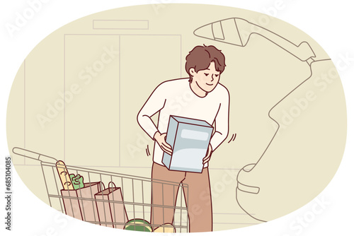 Happy young man loading groceries in car. Smiling guy putting products from supermarket in automobile. Shopping concept. Vector illustration.