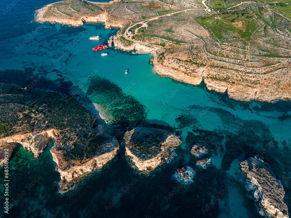 Azure paradise of Blue Lagoon in Malta aerial photo. A breathtaking tapestry of turquoise waters and rocky allure.