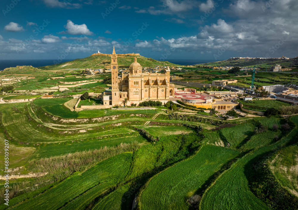 Aerial Drone photo of The Sanctuary of Ta’ Pinu in Gozo, Malta—a revered pilgrimage site with spiritual significance. Aerial Drone photo of The Sanctuary of Ta’ Pinu in Gozo, Malta—a revered pilgrimage site with spiritual significance.