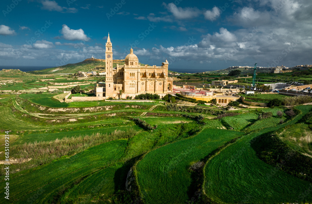 Aerial Drone photo of The Sanctuary of Ta’ Pinu in Gozo, Malta—a revered pilgrimage site with spiritual significance.