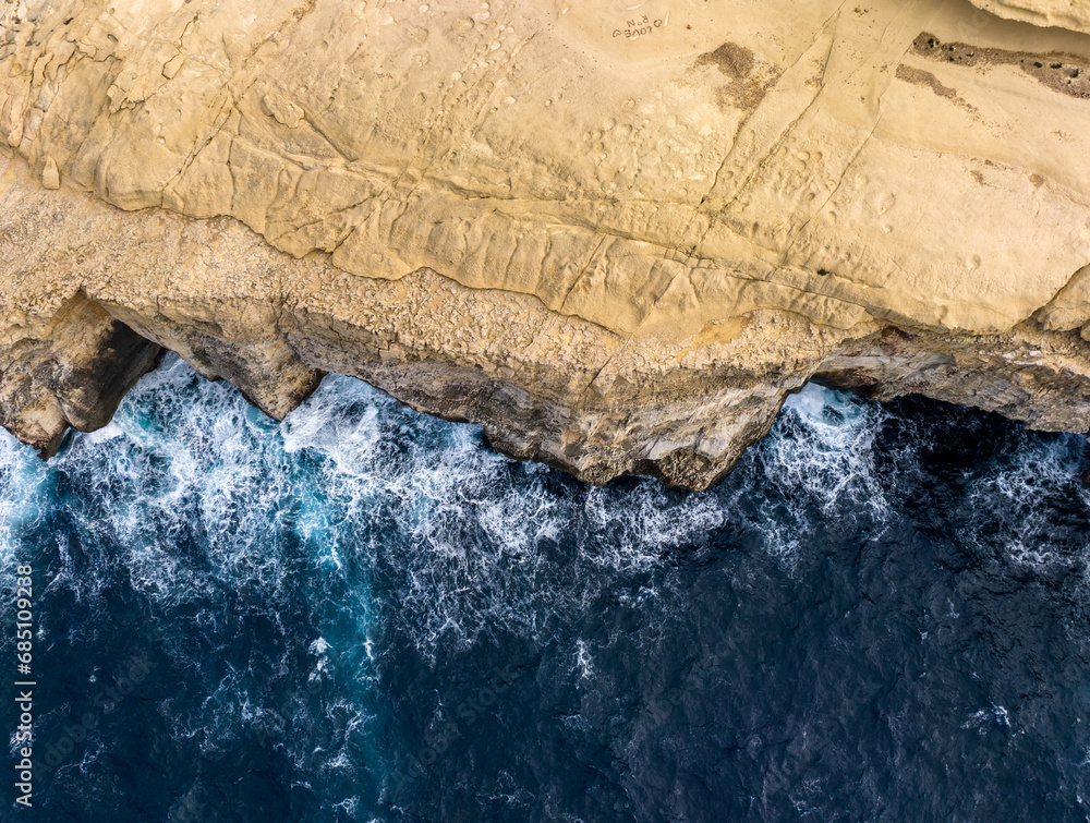 Aerial View of Gozo island in Malta. Rocky shores from above—an aerial snapshot revealing the island's untamed coastal allure.