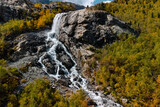 Alibek waterfall in the Caucasus mountains and autumn forest