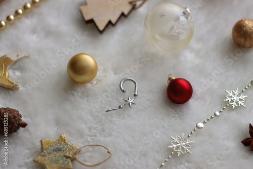 Various colorful Christmas oranments and white faux fur blanket. Selective focus. photo