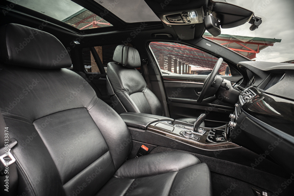 Car inside. Interior of prestige modern car. Comfortable leather seats. Black cockpit with on isolated white background.