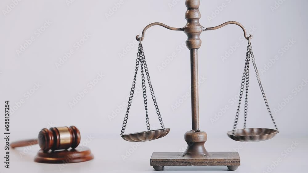 Business and lawyers discussing contract papers with brass scale on desk in office. Law, legal services, advice, justice and law concept picture with film grain effect Business and lawyers discussing contract papers with brass scale on desk in office. Law, legal services, advice, justice and law concept picture with film grain effect