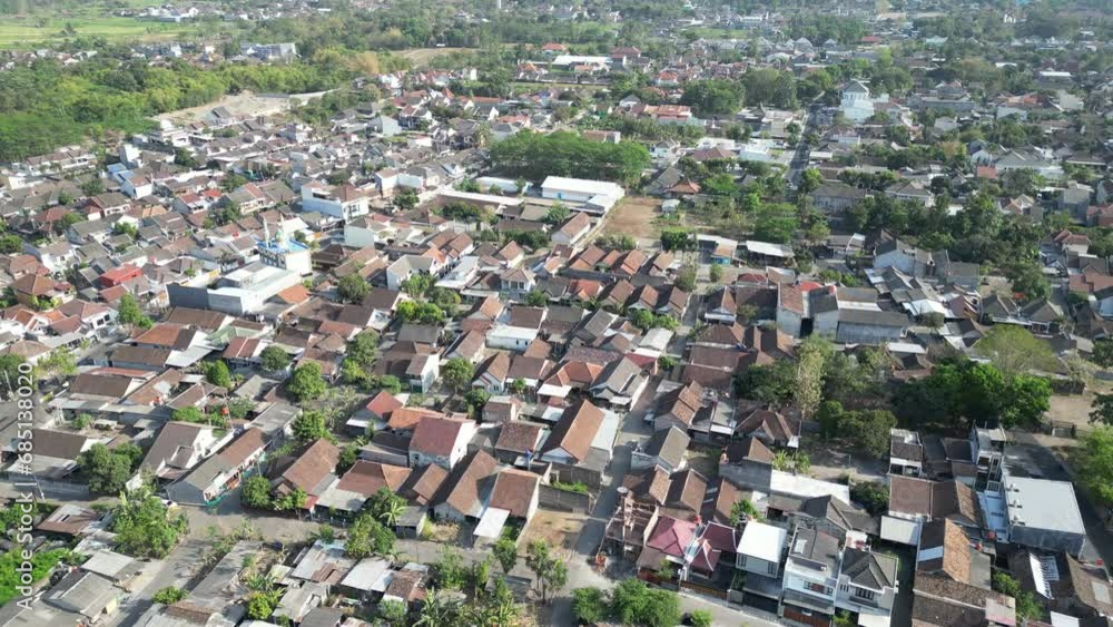 Aerial view of Jogja City with buildings, crowded vehicles traffic in morning sunlight. Sleman cityscape urban landscape. Population density is displacing agricultural land and forests. Aerial view of Jogja City with buildings, crowded vehicles traffic in morning sunlight. Sleman cityscape urban landscape. Population density is displacing agricultural land and forests.